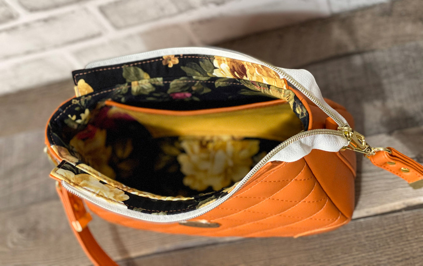 Orange quilted handbag with gold hardware. Inside view.