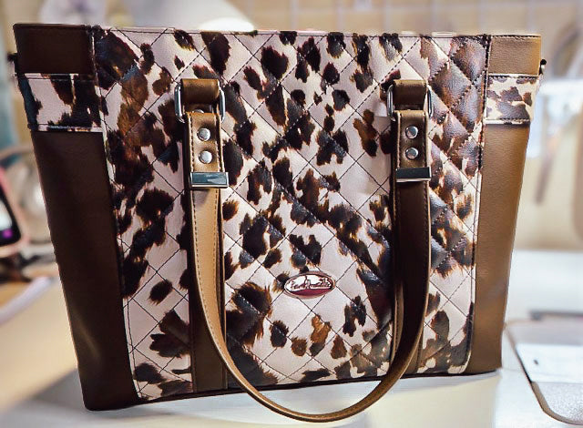 Brown cow print faux leather tote. 