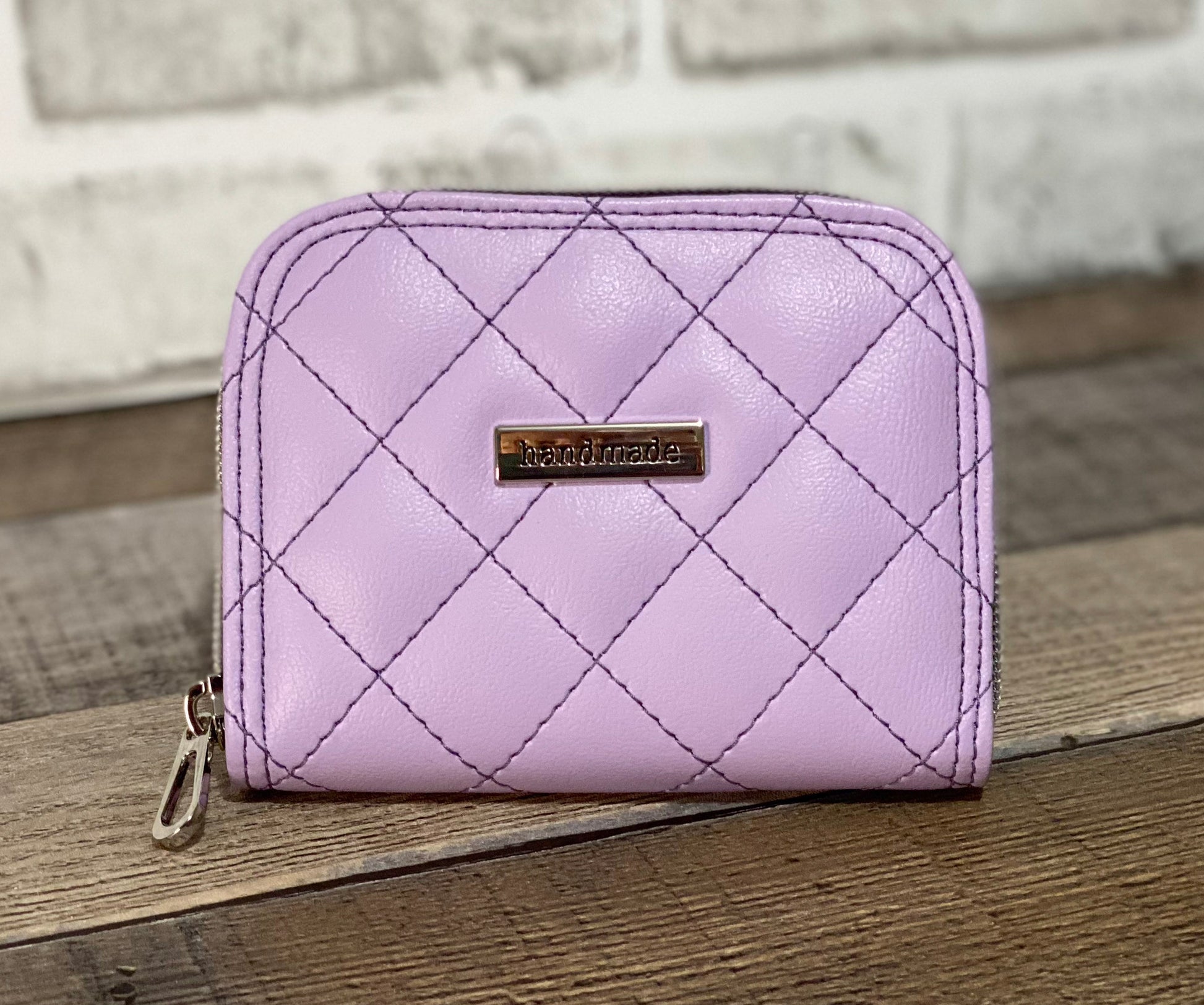 Quilted lilac zip around wallet. Front view