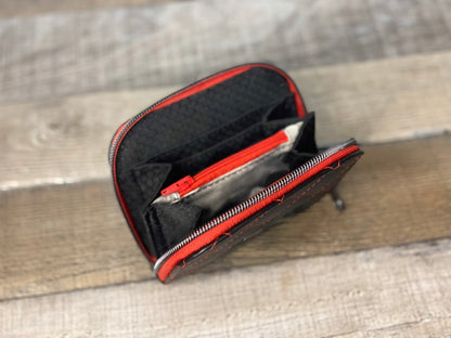 Black quilted faux leather with red thread. Lining view