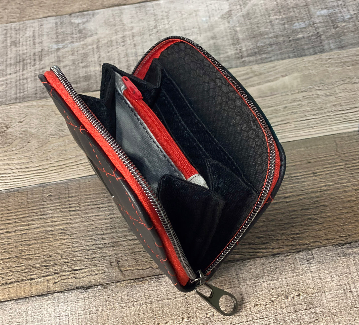 Black quilted faux leather with red thread.  Lining view