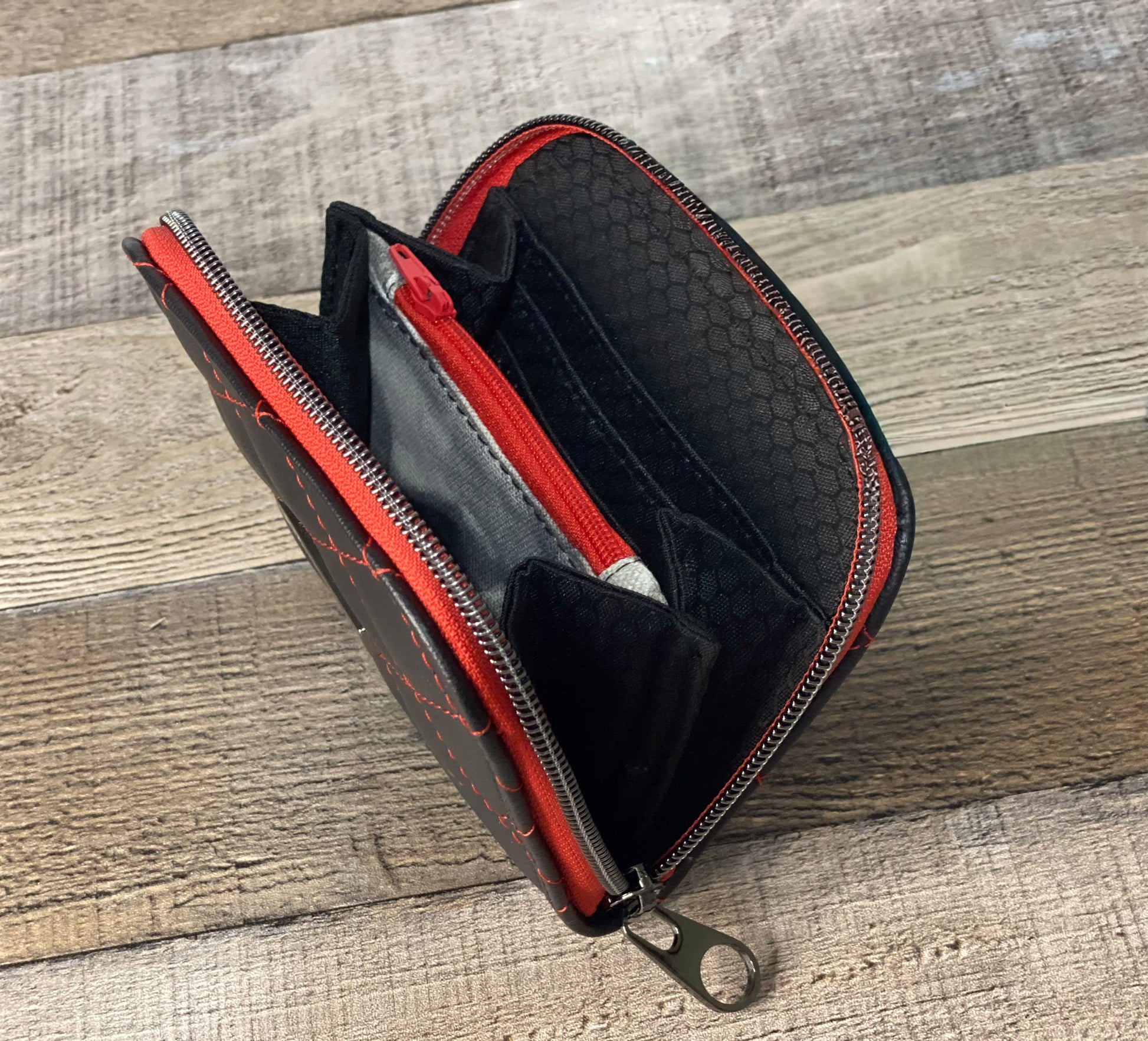 Black quilted faux leather with red thread.  Lining view