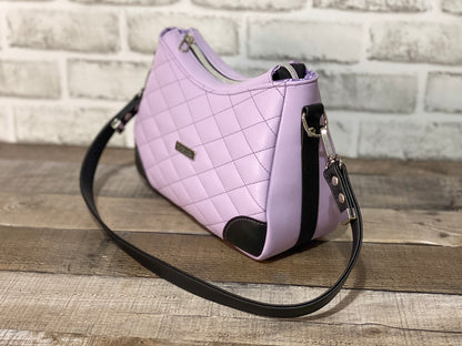 Quilted lilac purple handbag with black accents. Side view 