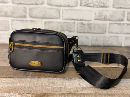 Black hip bag or can be used as a crossbody. Antique gold hardware front panel with strap. 