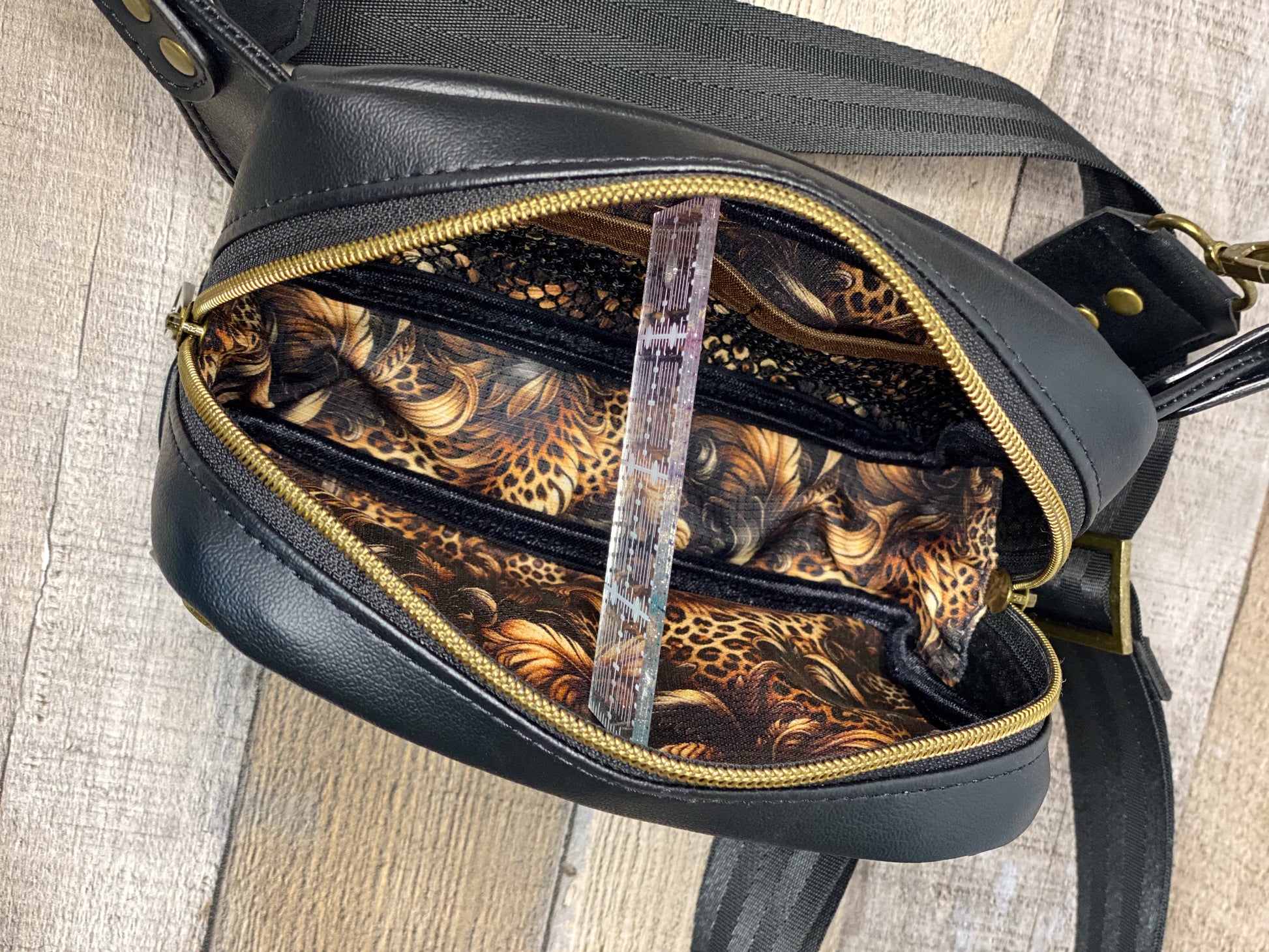 Hip bag showing interior leopard print lining. 