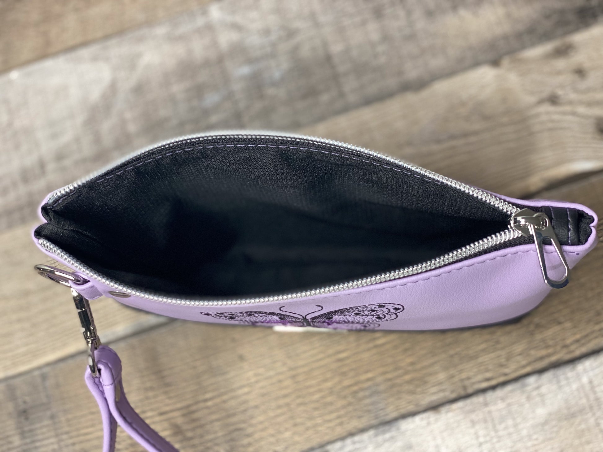Lilac wristlet with embroidered butterfly interior view
