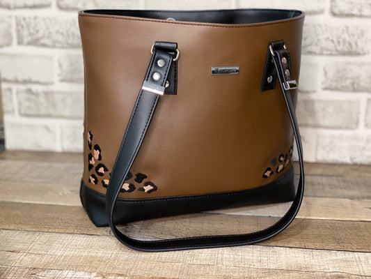 Brown handbag with black accents and leopard print details.