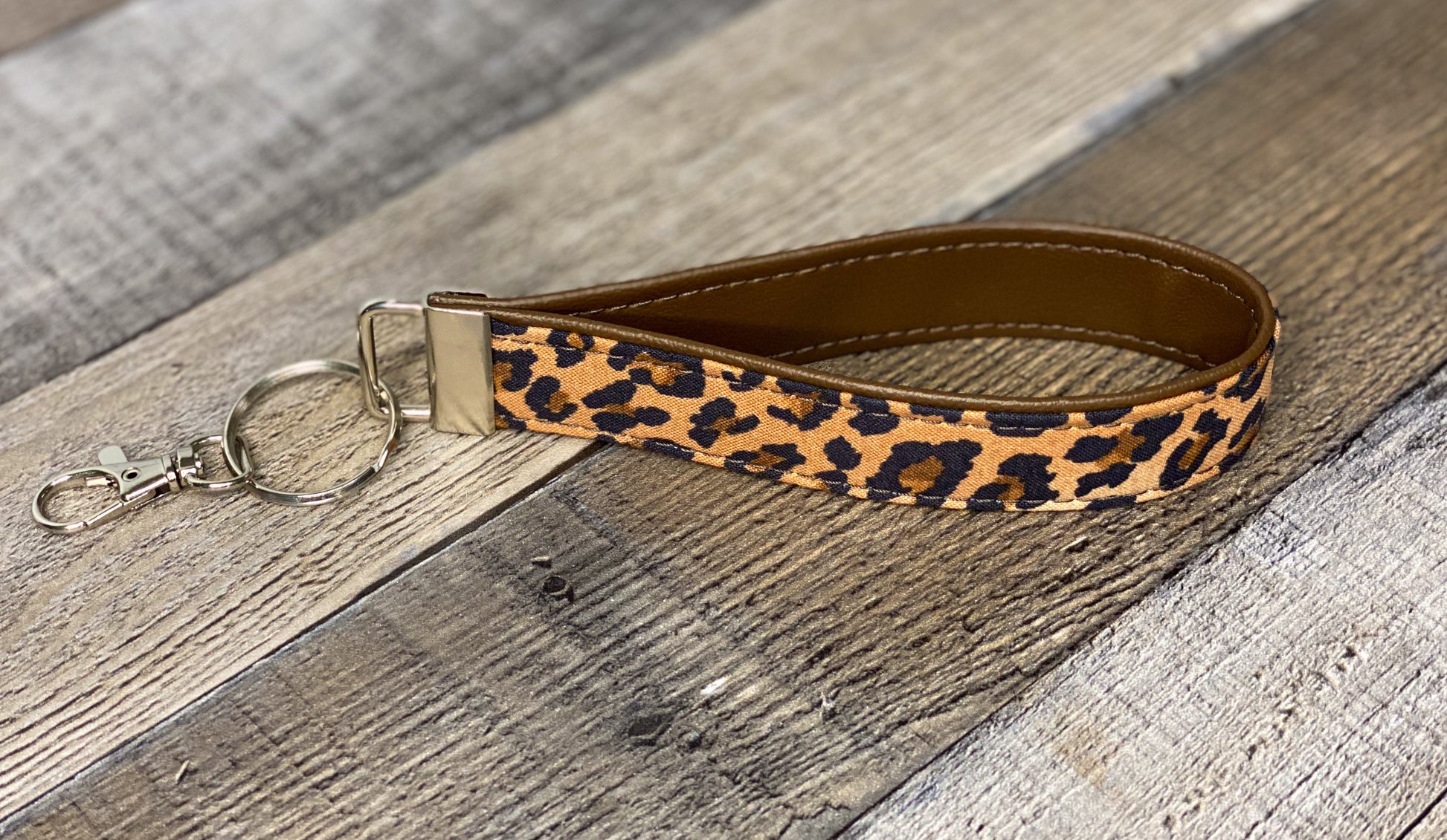 Brown leopard print key fob on a wooden surface