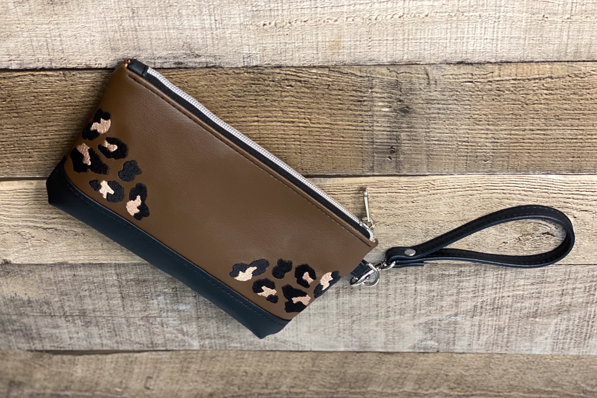 Brown wristlet with leopard print accents. Back View. 