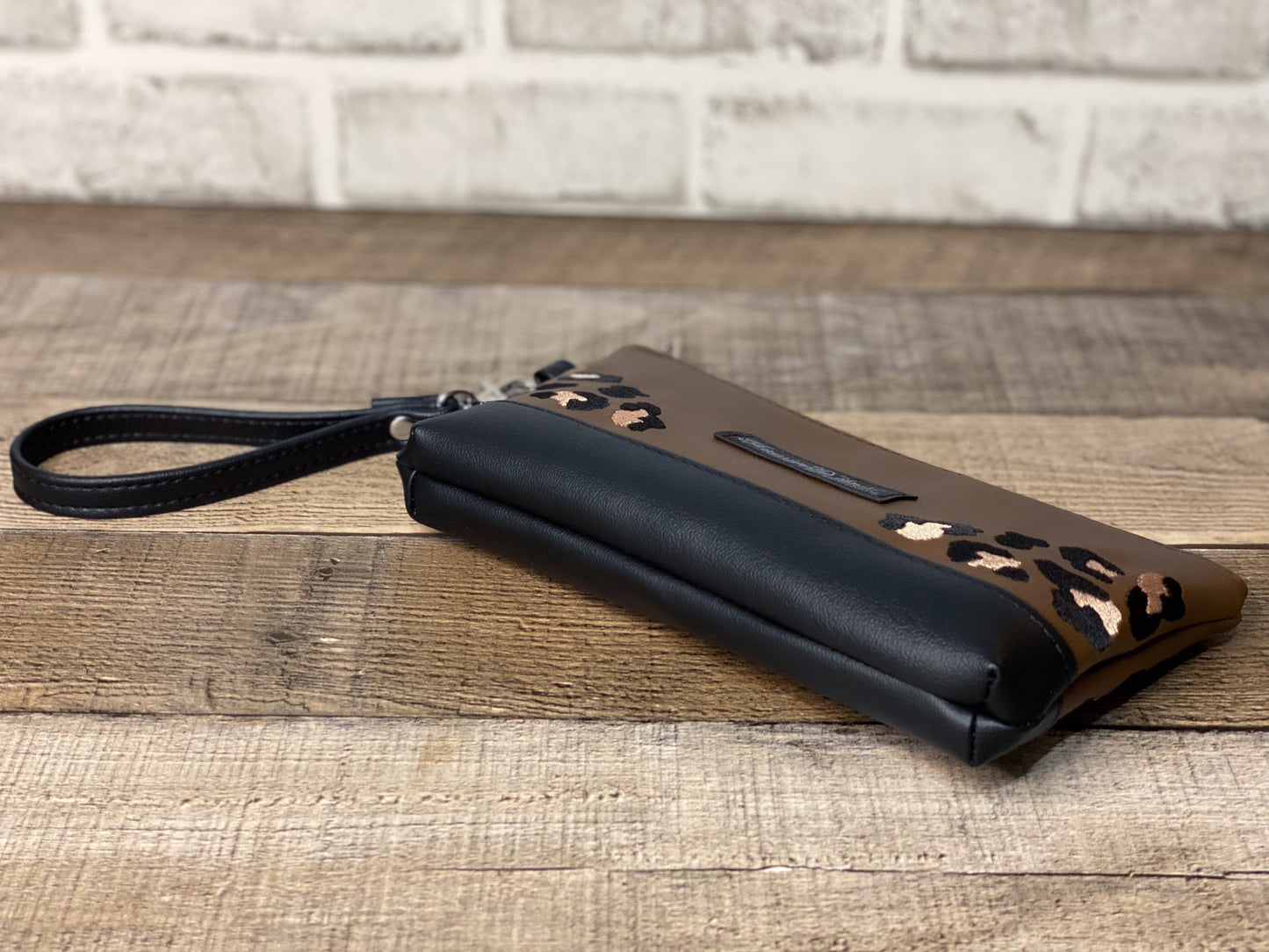 Brown wristlet with leopard print accents.