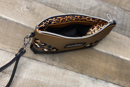 Small pouch with leopard print interior on a wooden surface