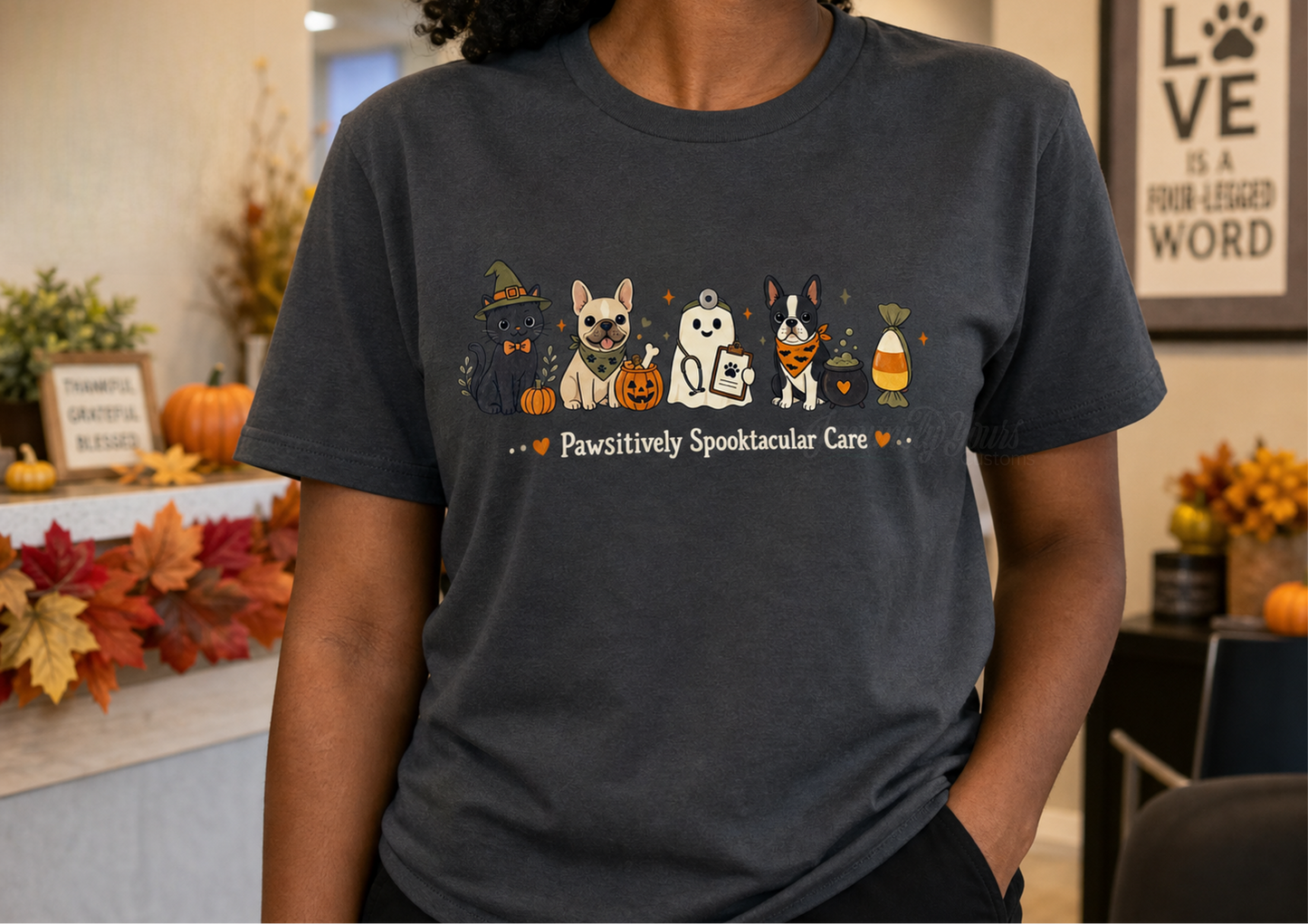 A person wearing a dark gray custom DTF t-shirt with a colorful graphic of a black cat, frenchie, Boston terrier and vet ghost. 
