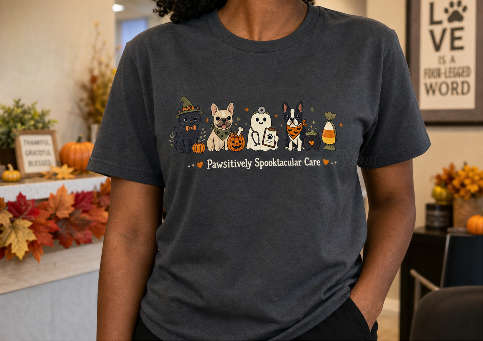 A person wearing a dark gray custom DTF t-shirt with a colorful graphic of a black cat, frenchie, Boston terrier and vet ghost. 